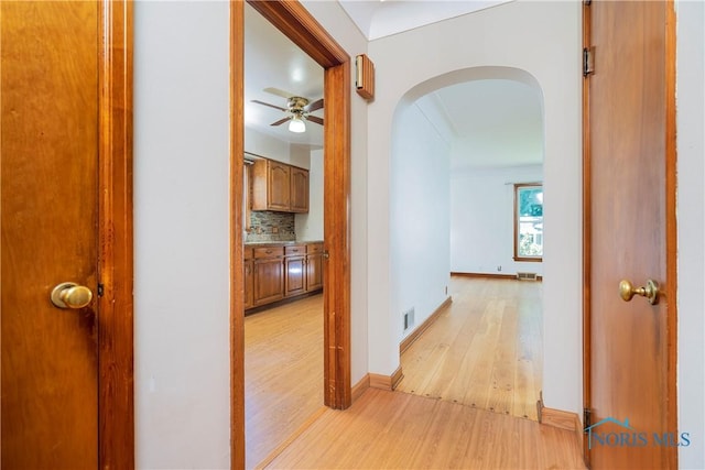 3328 Island Ave, Toledo, OH 43614 - corridor with arched walkways and light wood-style flooring