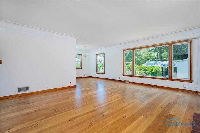 3328 Island Ave, Toledo, OH 43614 - unfurnished room featuring a chandelier, light wood-style flooring, and crown molding