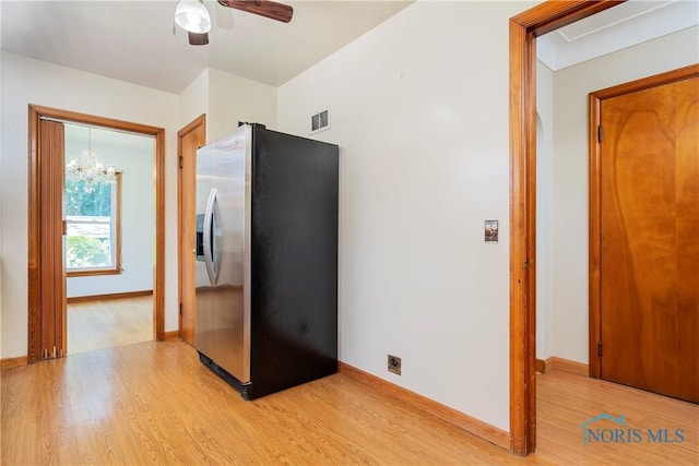 3328 Island Ave, Toledo, OH 43614 - kitchen featuring stainless steel fridge, light wood-style floors, a ceiling fan, and a chandelier