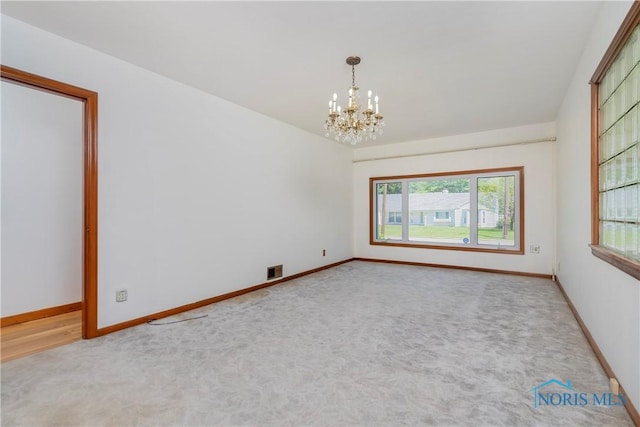 3328 Island Ave, Toledo, OH 43614 - carpeted empty room with a chandelier and baseboards