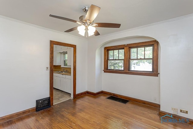 2529 Greenbriar Rd, Toledo, OH 43607 - spare room with arched walkways, hardwood / wood-style floors, ornamental molding, and ceiling fan