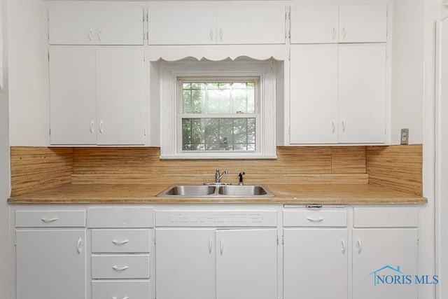 2529 Greenbriar Rd, Toledo, OH 43607 - kitchen featuring white cabinets, light countertops, and tasteful backsplash