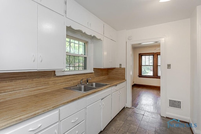 2529 Greenbriar Rd, Toledo, OH 43607 - kitchen with healthy amount of natural light, decorative backsplash, white cabinetry, and light countertops