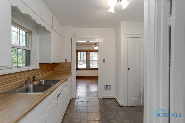 2529 Greenbriar Rd, Toledo, OH 43607 - kitchen featuring white cabinets, dark stone finish floors, light countertops, and a ceiling fan