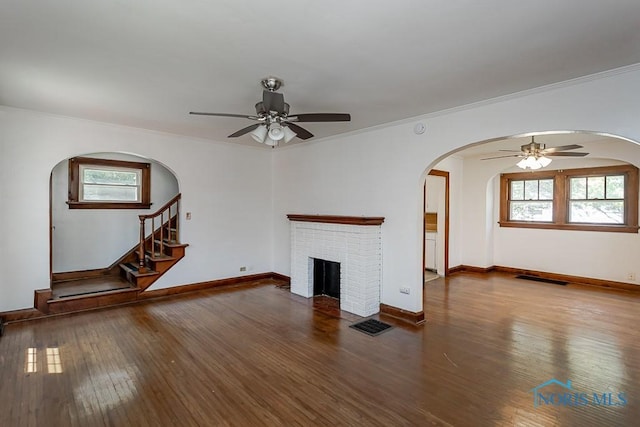 2529 Greenbriar Rd, Toledo, OH 43607 - unfurnished living room featuring a ceiling fan, hardwood / wood-style floors, arched walkways, and ornamental molding