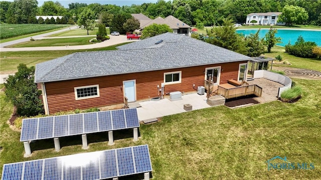 13362 Road 27C, Antwerp, OH 45813 - back of property with ground mounted solar panels, a shingled roof, and a yard