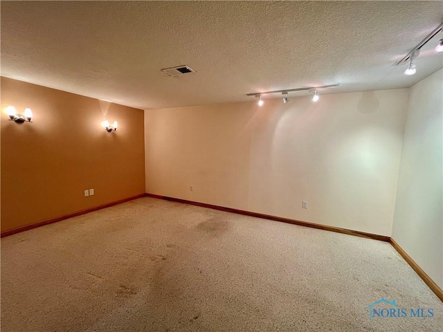 13362 Road 27C, Antwerp, OH 45813 - spare room with track lighting, a textured ceiling, and carpet flooring