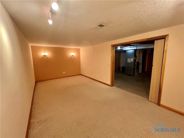 13362 Road 27C, Antwerp, OH 45813 - carpeted spare room with heating unit and a textured ceiling
