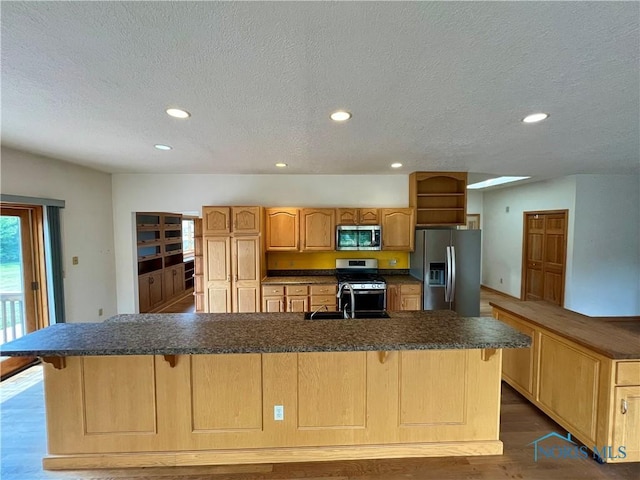13362 Road 27C, Antwerp, OH 45813 - kitchen featuring stainless steel appliances, recessed lighting, dark countertops, a kitchen bar, and a textured ceiling