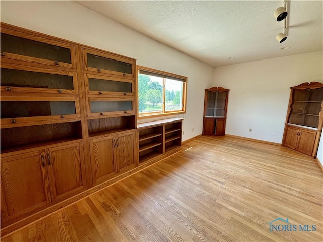 13362 Road 27C, Antwerp, OH 45813 - unfurnished living room featuring light wood-style flooring and a textured ceiling