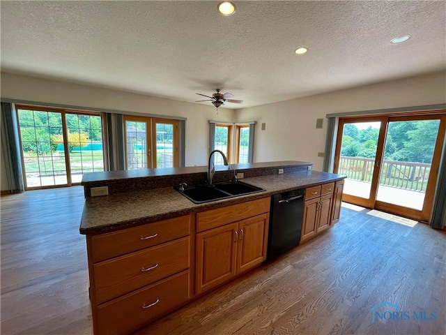 13362 Road 27C, Antwerp, OH 45813 - kitchen with black dishwasher, a textured ceiling, wood finished floors, ceiling fan, and brown cabinets