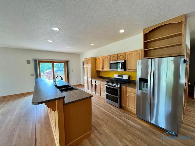 13362 Road 27C, Antwerp, OH 45813 - kitchen with stainless steel appliances, a textured ceiling, light wood finished floors, a center island with sink, and recessed lighting