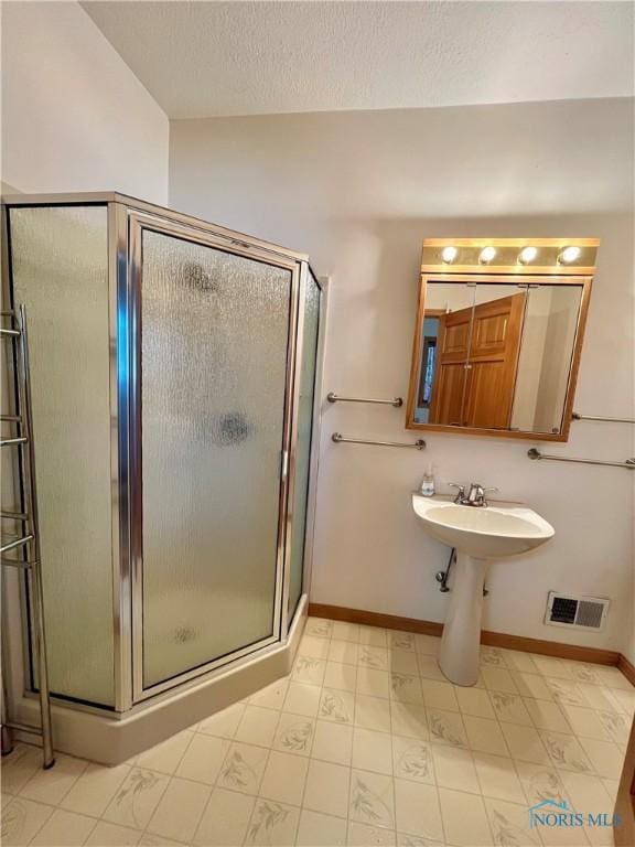 13362 Road 27C, Antwerp, OH 45813 - full bath with a stall shower, a textured ceiling, and tile patterned floors