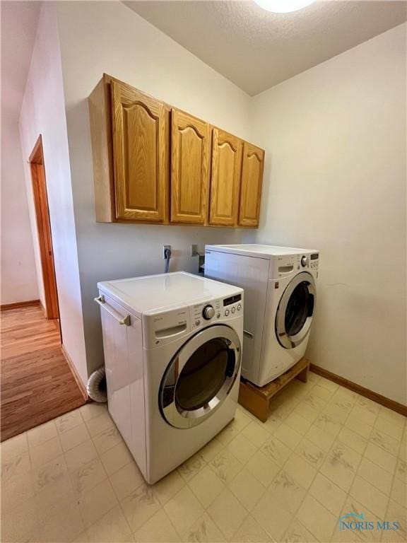 13362 Road 27C, Antwerp, OH 45813 - laundry room featuring washing machine and clothes dryer, cabinet space, and light floors