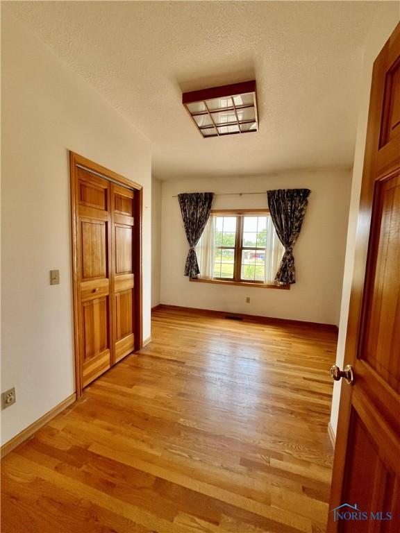 13362 Road 27C, Antwerp, OH 45813 - spare room with light wood-style flooring and a textured ceiling