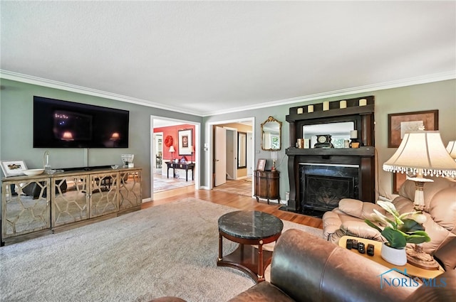 4567 Torquay Ave, Toledo, OH 43615 - living area with crown molding, wood finished floors, and a fireplace with flush hearth