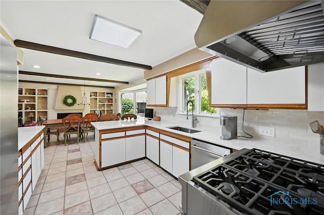4567 Torquay Ave, Toledo, OH 43615 - kitchen featuring ventilation hood, stainless steel dishwasher, light countertops, white cabinets, and tasteful backsplash