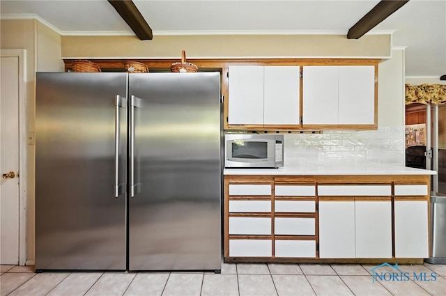 4567 Torquay Ave, Toledo, OH 43615 - kitchen with high end fridge, beam ceiling, light countertops, paneled refrigerator, and white cabinets