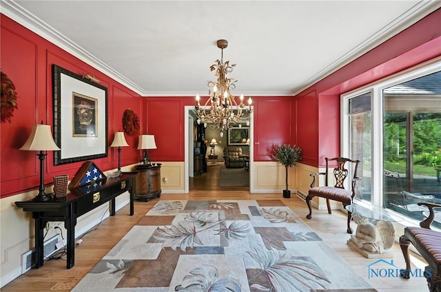 4567 Torquay Ave, Toledo, OH 43615 - sitting room featuring a decorative wall, a chandelier, light wood-style floors, and crown molding