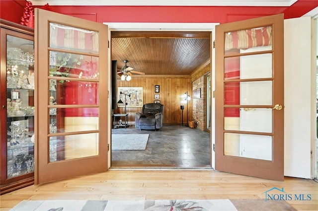 4567 Torquay Ave, Toledo, OH 43615 - foyer with wood ceiling, wood-type flooring, wooden walls, ceiling fan, and french doors