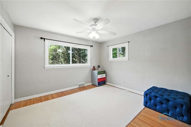 4567 Torquay Ave, Toledo, OH 43615 - unfurnished bedroom with multiple windows, wood finished floors, a closet, and a ceiling fan