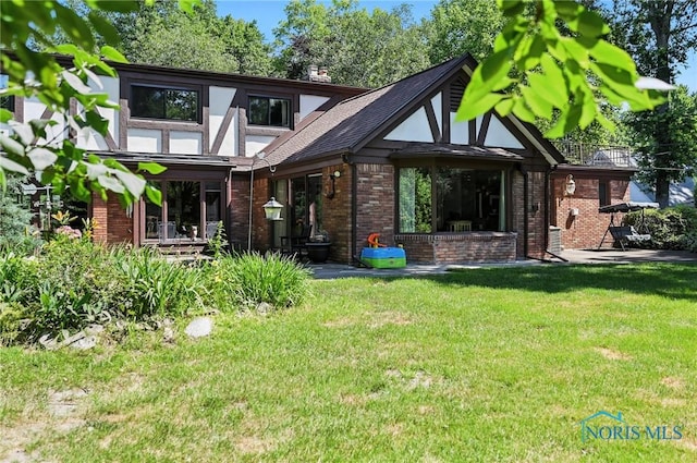 4567 Torquay Ave, Toledo, OH 43615 - rear view of property with a lawn, brick siding, a shingled roof, and a chimney
