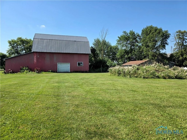 12406 Cross Creek Rd, Bowling Green, OH 43402 - view of grassy yard with a detached garage and an outbuilding