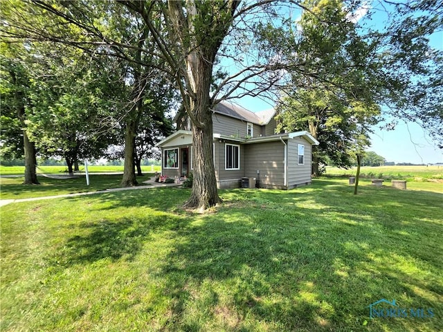 12406 Cross Creek Rd, Bowling Green, OH 43402 - view of home's exterior with a yard and a central AC unit