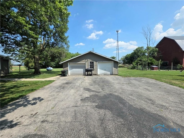 12406 Cross Creek Rd, Bowling Green, OH 43402 - view of property exterior with an outbuilding, a yard, and a detached garage