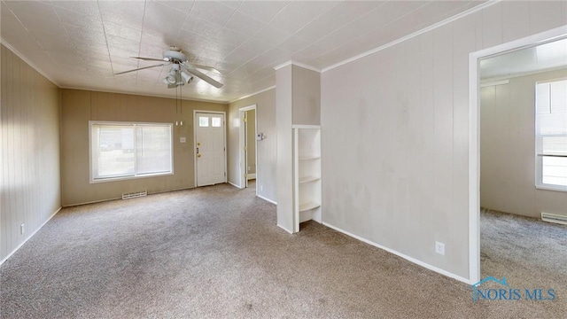 1534 Pinewood Ave, Toledo, OH 43607 - carpeted empty room featuring a ceiling fan, healthy amount of natural light, and crown molding