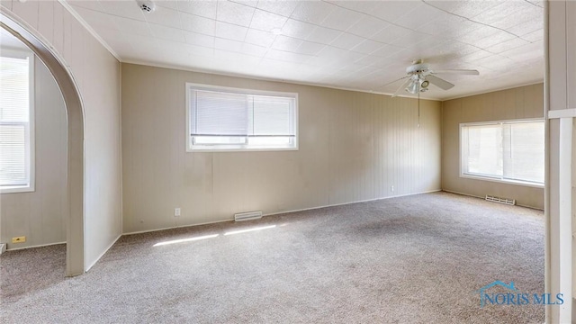 1534 Pinewood Ave, Toledo, OH 43607 - unfurnished room with carpet, ceiling fan, and arched walkways