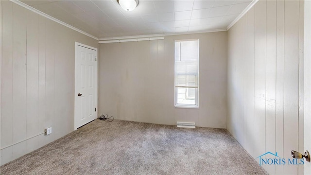 1534 Pinewood Ave, Toledo, OH 43607 - spare room with ornamental molding, carpet floors, healthy amount of natural light, and wood walls