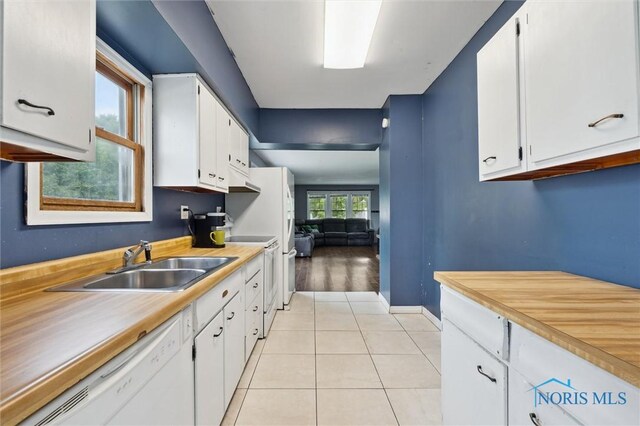 1285 Glenview Rd, Toledo, OH 43614 - kitchen featuring white appliances, white cabinets, light tile patterned floors, light countertops, and under cabinet range hood