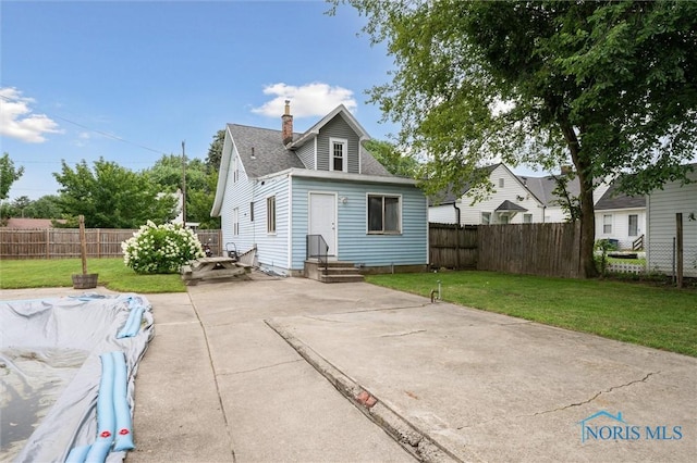 1285 Glenview Rd, Toledo, OH 43614 - back of property with a fenced backyard, a patio, a chimney, and concrete driveway