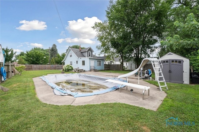 1285 Glenview Rd, Toledo, OH 43614 - view of pool with a shed, a fenced backyard, a water slide, and a diving board