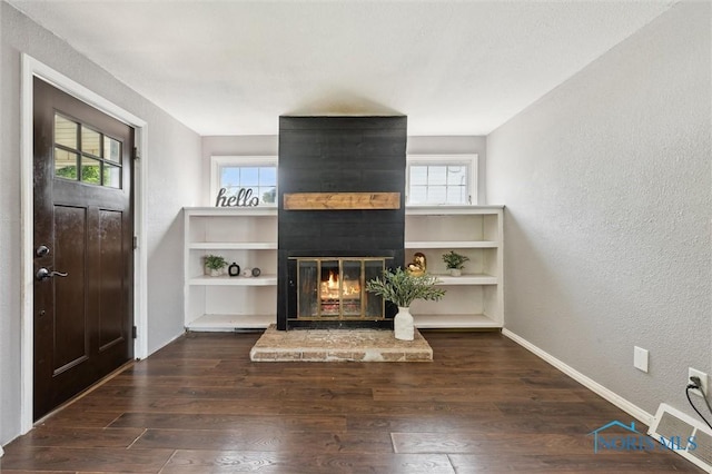 1285 Glenview Rd, Toledo, OH 43614 - unfurnished living room with a textured wall, a large fireplace, and wood finished floors