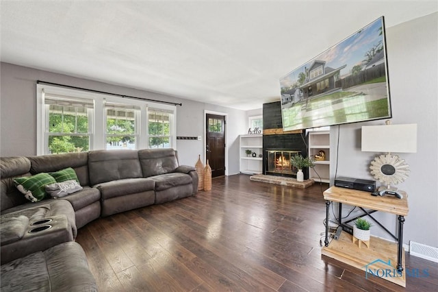 1285 Glenview Rd, Toledo, OH 43614 - living area featuring a glass covered fireplace, hardwood / wood-style floors, and plenty of natural light