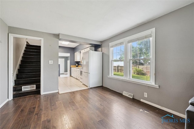 1285 Glenview Rd, Toledo, OH 43614 - unfurnished living room with stairs and wood-type flooring