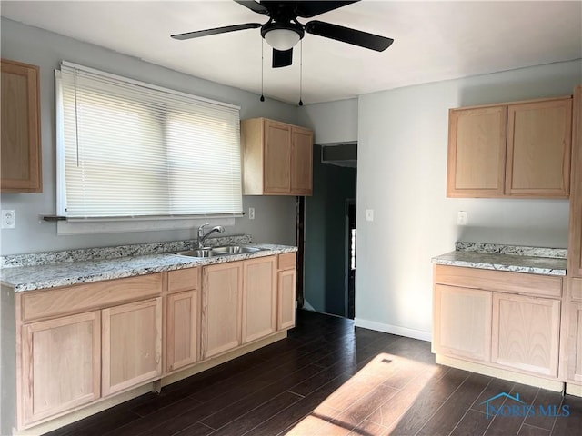 3927 Vermaas Ave, Toledo, OH 43612 - kitchen featuring light brown cabinets, a ceiling fan, dark wood-style flooring, and light stone counters
