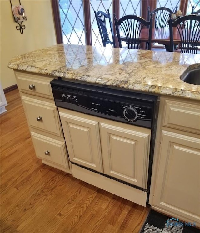 3704 Brookside Rd, Ottawa Hills, OH 43606 - kitchen with light wood-style flooring, light stone countertops, paneled dishwasher, and white cabinetry