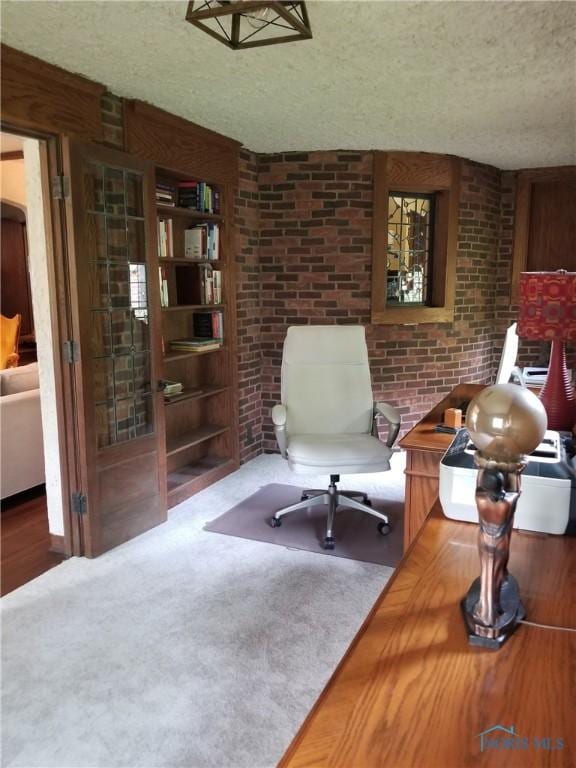 3704 Brookside Rd, Ottawa Hills, OH 43606 - sitting room featuring a textured ceiling, carpet floors, a desk, brick wall, and built in shelves