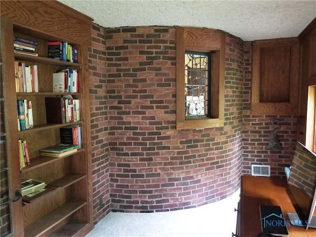 3704 Brookside Rd, Ottawa Hills, OH 43606 - interior space featuring brick wall and a textured ceiling