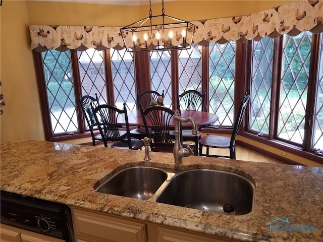 3704 Brookside Rd, Ottawa Hills, OH 43606 - kitchen featuring light stone counters, a chandelier, and hanging light fixtures