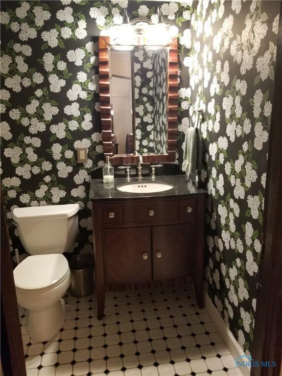 3704 Brookside Rd, Ottawa Hills, OH 43606 - half bath with wallpapered walls, tile patterned floors, and vanity