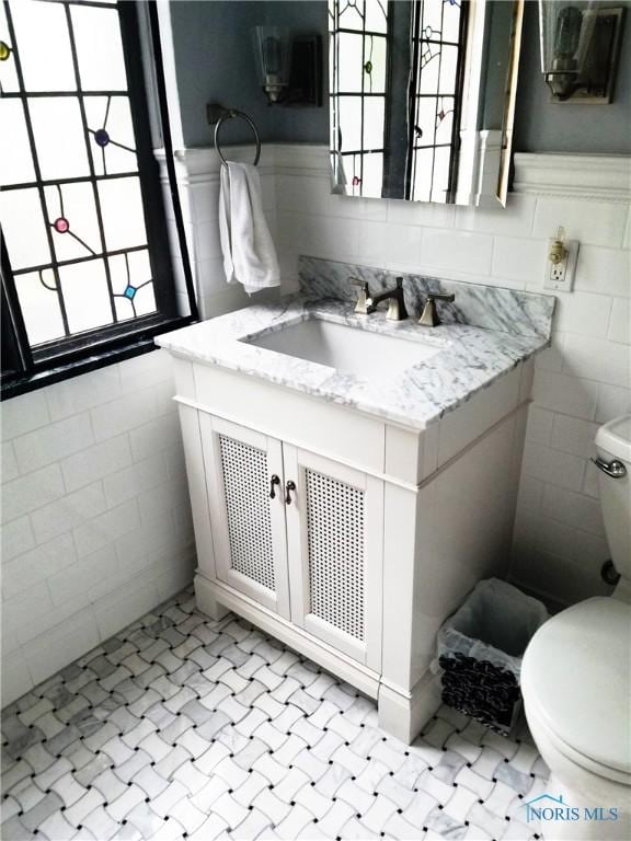 3704 Brookside Rd, Ottawa Hills, OH 43606 - half bath with vanity, tile walls, and wainscoting