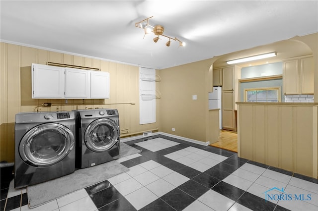 545 Wallace Ave, Bowling Green, OH 43402 - washroom with washing machine and dryer, arched walkways, cabinet space, and dark tile patterned floors