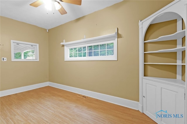 545 Wallace Ave, Bowling Green, OH 43402 - unfurnished room featuring a ceiling fan, healthy amount of natural light, and wood finished floors