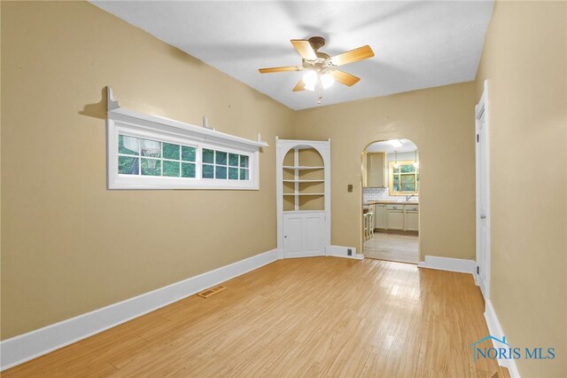 545 Wallace Ave, Bowling Green, OH 43402 - empty room featuring ceiling fan, arched walkways, and light wood-type flooring