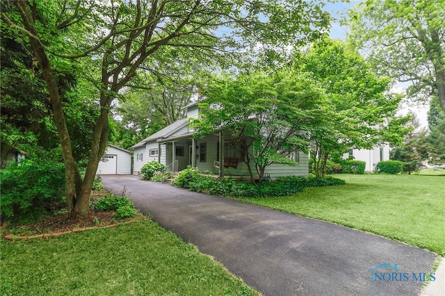 545 Wallace Ave, Bowling Green, OH 43402 - view of front of home featuring an outdoor structure, a front yard, a garage, and a porch