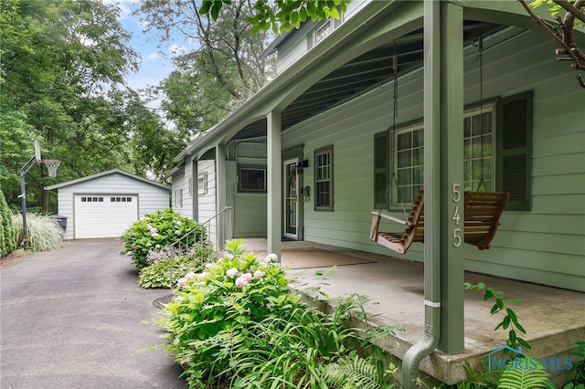 545 Wallace Ave, Bowling Green, OH 43402 - porch featuring an outdoor structure, a garage, and driveway
